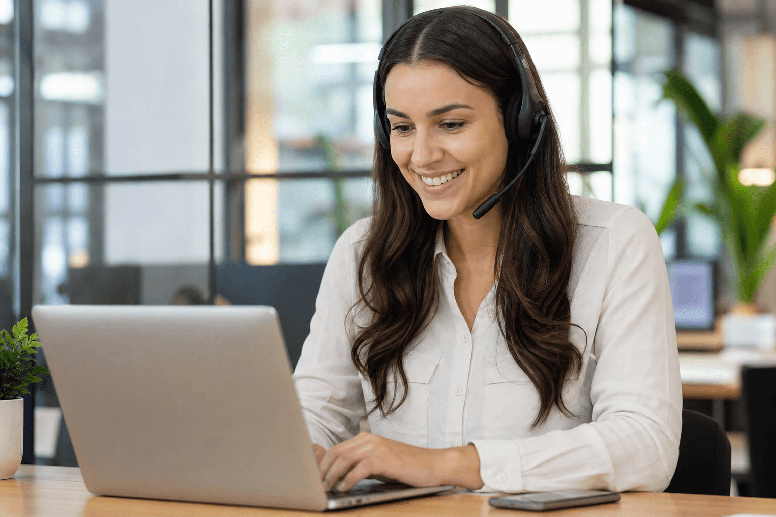 Medicare EHR support specialist with headset assisting a customer